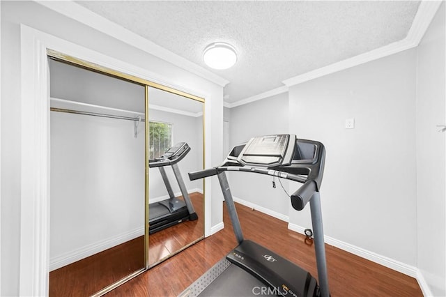 157 E 70th St, Los Angeles, CA 90003 - workout area featuring wood finished floors, ornamental molding, baseboards, and a textured ceiling
