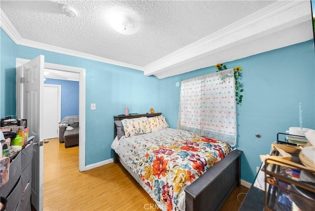 157 E 70th St, Los Angeles, CA 90003 - bedroom featuring ornamental molding, a textured ceiling, wood finished floors, and baseboards