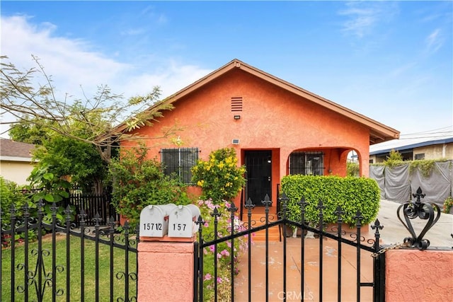 157 E 70th St, Los Angeles, CA 90003 - view of front of property featuring stucco siding and a gate