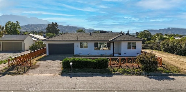 12563 3rd St, Yucaipa, CA 92399 - ranch-style house with driveway, a mountain view, a garage, and stucco siding