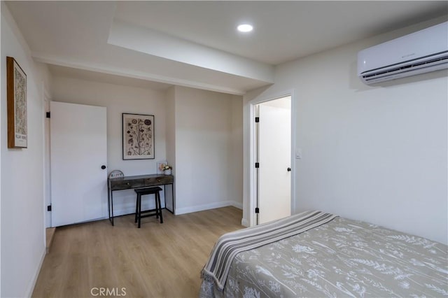 12563 3rd St, Yucaipa, CA 92399 - bedroom featuring a wall mounted air conditioner, wood finished floors, and baseboards