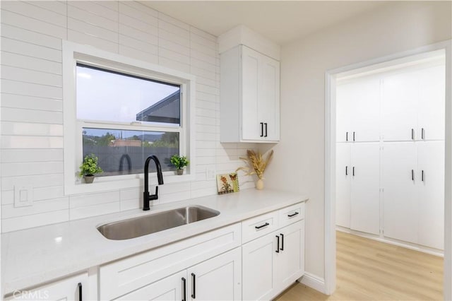 12563 3rd St, Yucaipa, CA 92399 - kitchen featuring a sink, light countertops, white cabinets, and decorative backsplash