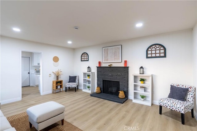 12563 3rd St, Yucaipa, CA 92399 - living room with light wood finished floors, recessed lighting, a fireplace, and baseboards
