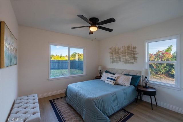 12563 3rd St, Yucaipa, CA 92399 - bedroom featuring multiple windows, wood finished floors, baseboards, and a ceiling fan