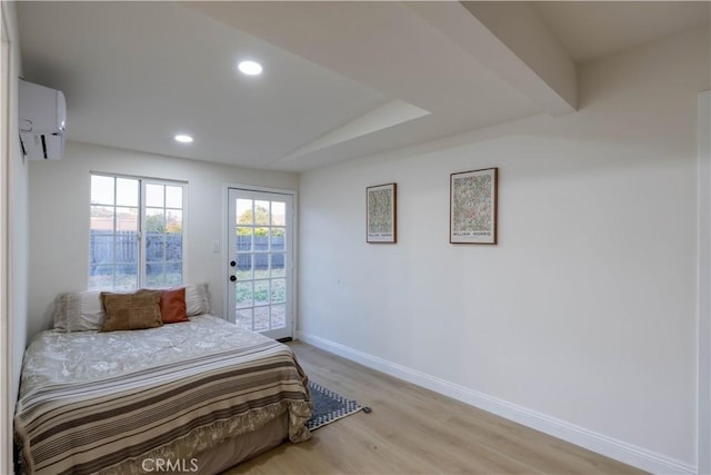 12563 3rd St, Yucaipa, CA 92399 - bedroom with a wall mounted AC, access to exterior, baseboards, light wood-type flooring, and recessed lighting