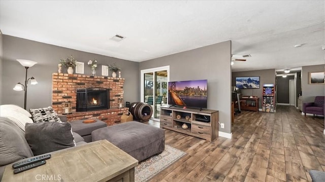 21248 Rancherias Rd, Apple Valley, CA 92307 - living area featuring hardwood / wood-style floors, a brick fireplace, and baseboards