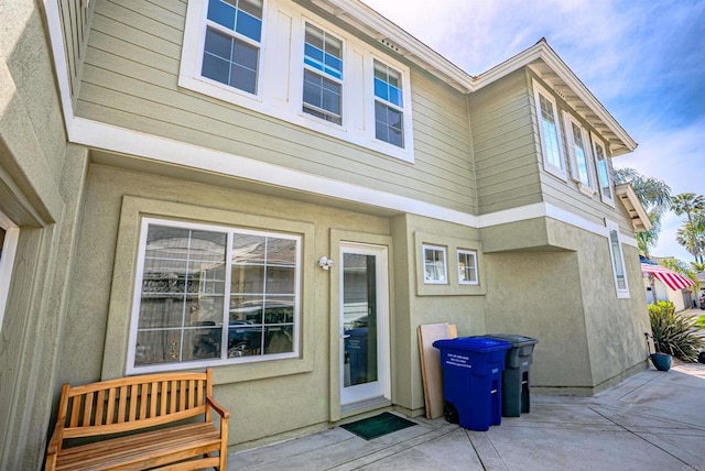 7040 Whitewater St, Carlsbad, CA 92011 - entrance to property with a patio and stucco siding