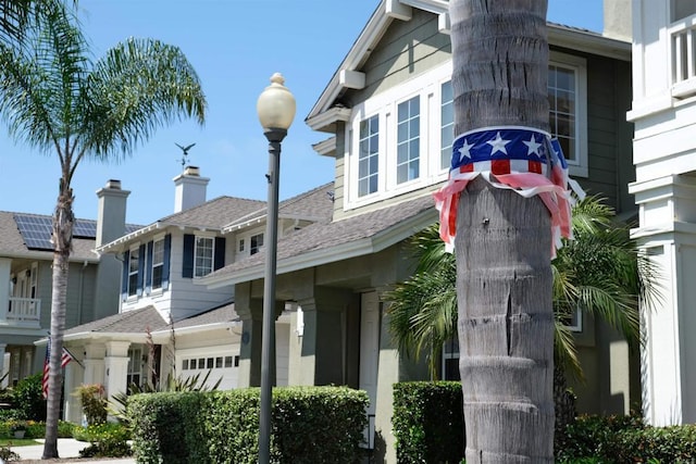 7040 Whitewater St, Carlsbad, CA 92011 - view of side of home with a garage and a shingled roof