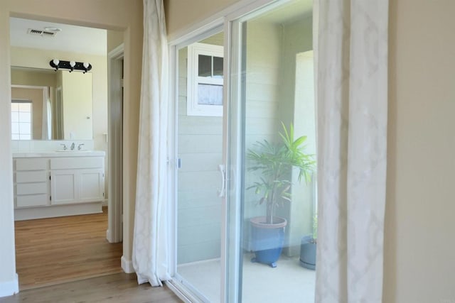 7040 Whitewater St, Carlsbad, CA 92011 - hall with light wood finished floors and a sink
