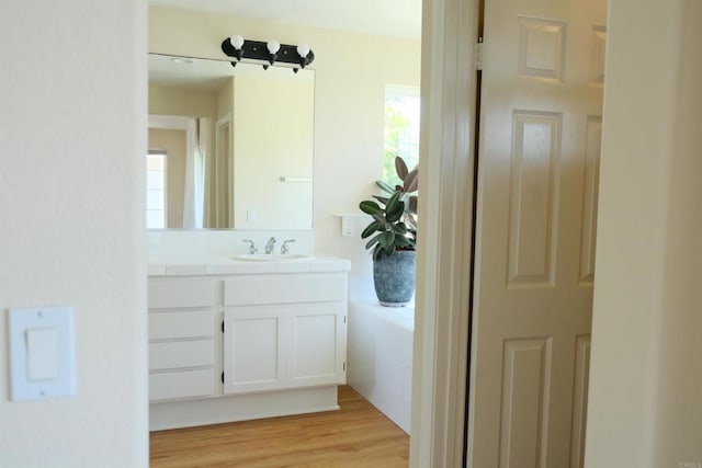 7040 Whitewater St, Carlsbad, CA 92011 - bathroom with vanity and wood finished floors