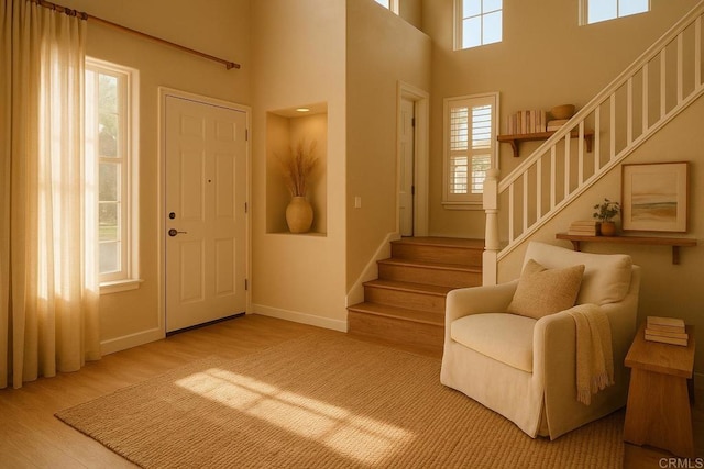 7040 Whitewater St, Carlsbad, CA 92011 - entryway with stairway, wood finished floors, and a high ceiling
