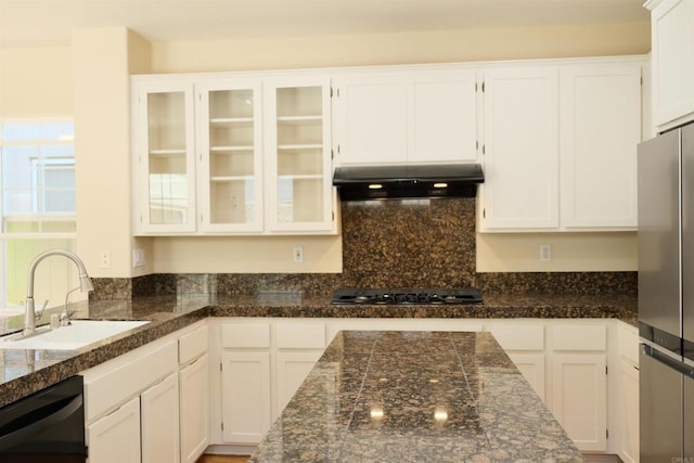 7040 Whitewater St, Carlsbad, CA 92011 - kitchen with under cabinet range hood, freestanding refrigerator, black dishwasher, white cabinets, and glass insert cabinets