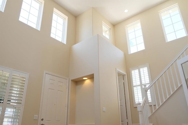 7040 Whitewater St, Carlsbad, CA 92011 - foyer entrance featuring a towering ceiling, plenty of natural light, and stairs