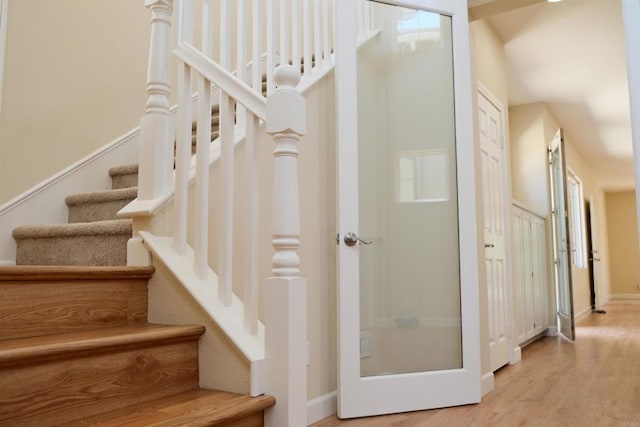 7040 Whitewater St, Carlsbad, CA 92011 - staircase featuring wood finished floors and baseboards