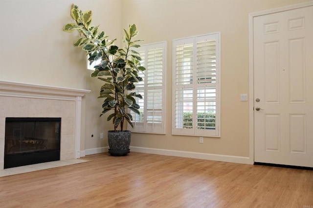 7040 Whitewater St, Carlsbad, CA 92011 - living area featuring wood finished floors and a tile fireplace