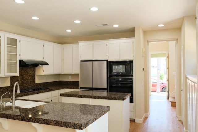 7040 Whitewater St, Carlsbad, CA 92011 - kitchen featuring black appliances, under cabinet range hood, recessed lighting, light wood finished floors, and white cabinetry