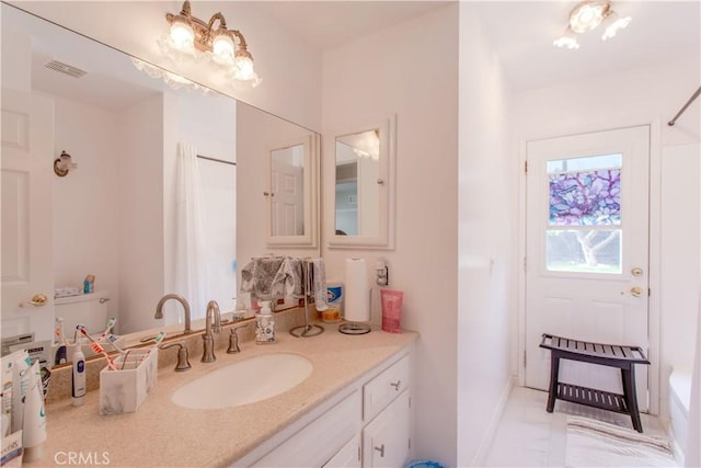 2546 Northmoor Dr, Corona, CA 92882 - bathroom with vanity, marble look tile flooring, baseboards, and a tub