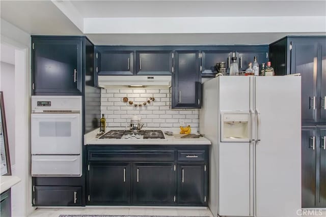 2546 Northmoor Dr, Corona, CA 92882 - kitchen with white appliances, a warming drawer, light countertops, backsplash, and under cabinet range hood