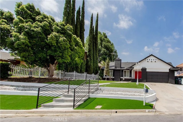 2546 Northmoor Dr, Corona, CA 92882 - view of front of home with an attached garage, driveway, and a chimney