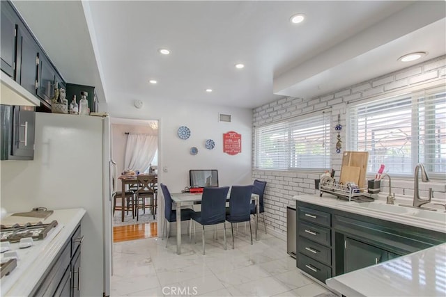 2546 Northmoor Dr, Corona, CA 92882 - kitchen with light marble finish floors, light countertops, a sink, white gas stovetop, and recessed lighting