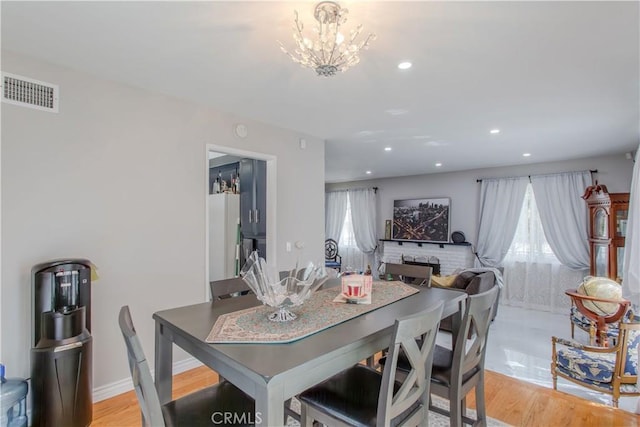 2546 Northmoor Dr, Corona, CA 92882 - dining area featuring recessed lighting, a chandelier, light wood finished floors, and baseboards