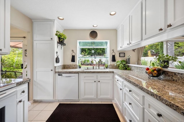 6839 Caminito Sueno, Carlsbad, CA 92009 - kitchen with a sink, white dishwasher, white cabinets, light tile patterned floors, and recessed lighting