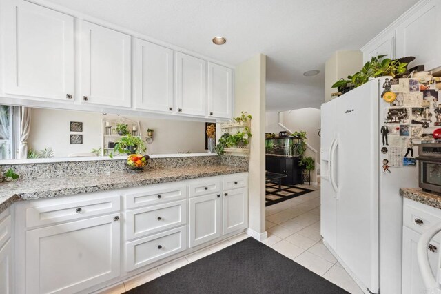 6839 Caminito Sueno, Carlsbad, CA 92009 - kitchen with white refrigerator with ice dispenser, light tile patterned floors, white cabinets, and light stone countertops
