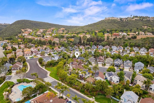 6839 Caminito Sueno, Carlsbad, CA 92009 - aerial view of property's location featuring a mountain backdrop, nearby suburban area, and a pool