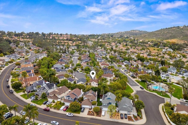 6839 Caminito Sueno, Carlsbad, CA 92009 - aerial overview of property's location featuring nearby suburban area, a pool area, and a mountain backdrop