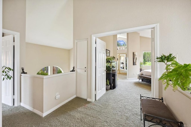 6839 Caminito Sueno, Carlsbad, CA 92009 - corridor with carpet floors, baseboards, and high vaulted ceiling