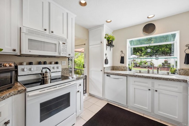 6839 Caminito Sueno, Carlsbad, CA 92009 - kitchen with white appliances, light tile patterned flooring, white cabinetry, recessed lighting, and light stone countertops
