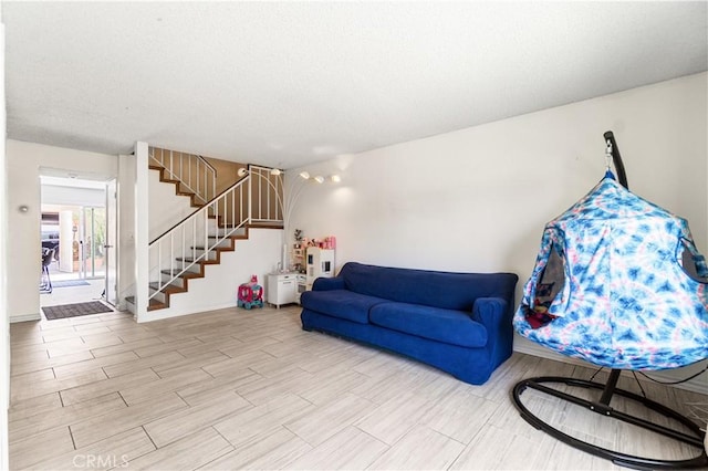 5950 Imperial Hwy Unit 48, South Gate, CA 90280 - living area featuring stairs, wood finished floors, baseboards, and a textured ceiling