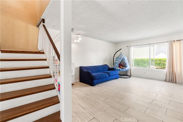 5950 Imperial Hwy Unit 48, South Gate, CA 90280 - living area featuring stairway, a textured ceiling, and light wood-style floors