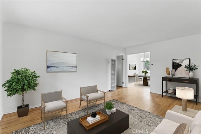 5802 Bowcroft St Unit 4, Los Angeles, CA 90016 - living room with wood finished floors, a chandelier, a heating unit, and baseboards