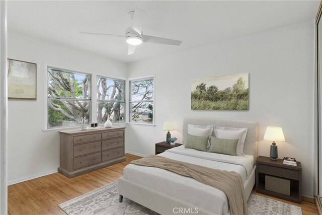 5802 Bowcroft St Unit 4, Los Angeles, CA 90016 - bedroom with light wood finished floors, ceiling fan, and baseboards