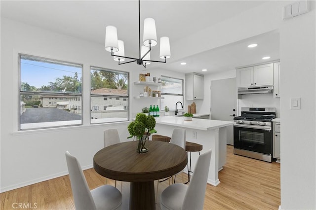 5802 Bowcroft St Unit 4, Los Angeles, CA 90016 - dining room featuring light wood-type flooring, a chandelier, recessed lighting, and baseboards