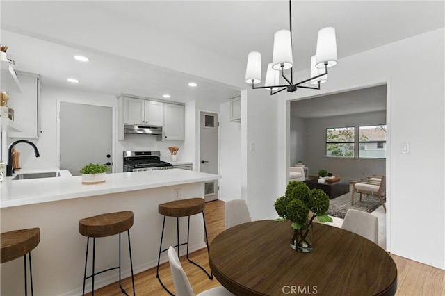 5802 Bowcroft St Unit 4, Los Angeles, CA 90016 - dining area featuring recessed lighting, light wood-style floors, and a chandelier