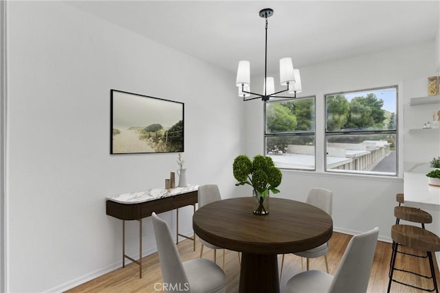 5802 Bowcroft St Unit 4, Los Angeles, CA 90016 - dining space with a chandelier, light wood-type flooring, and baseboards