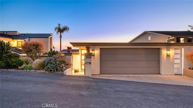 1155 Katella St, Laguna Beach, CA 92651 - view of front of house featuring driveway, an attached garage, and stucco siding