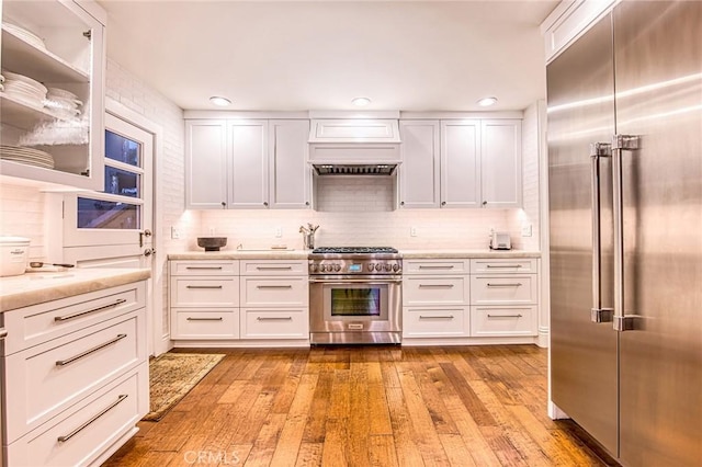 1155 Katella St, Laguna Beach, CA 92651 - kitchen with high end appliances, white cabinetry, decorative backsplash, and recessed lighting