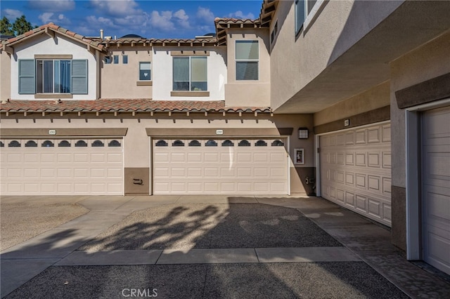 12909 Ternberry Ct, Tustin, CA 92782 - view of front of home with a tiled roof, stucco siding, and a garage