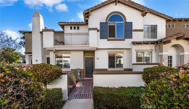 12909 Ternberry Ct, Tustin, CA 92782 - mediterranean / spanish home featuring a balcony, stucco siding, a chimney, and a tiled roof