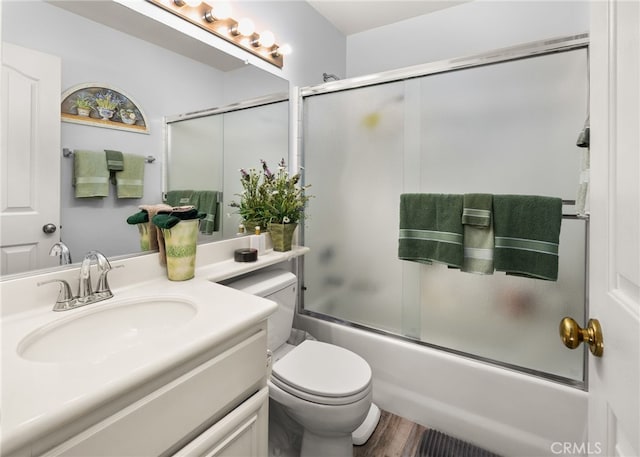 12909 Ternberry Ct, Tustin, CA 92782 - bathroom featuring vanity, combined bath / shower with glass door, wood finished floors, and toilet
