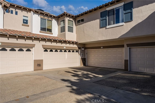 12909 Ternberry Ct, Tustin, CA 92782 - mediterranean / spanish house with a tile roof, stucco siding, a garage, and driveway