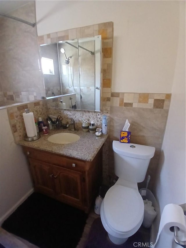 1831 W 68th St, Los Angeles, CA 90047 - bathroom with tile walls, vanity, toilet, a shower stall, and a wainscoted wall