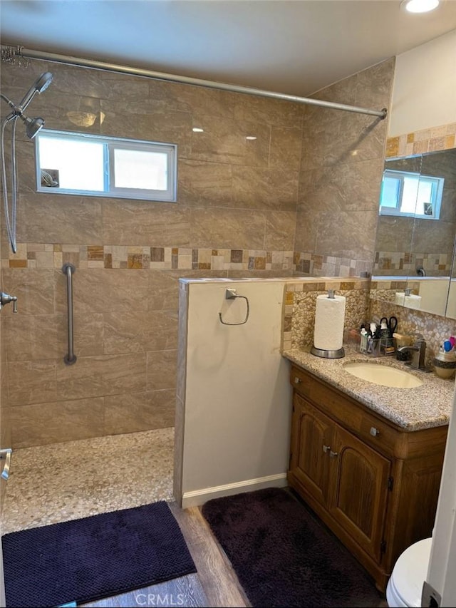 1831 W 68th St, Los Angeles, CA 90047 - bathroom with a tile shower, vanity, and toilet