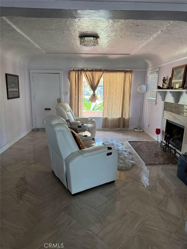 1831 W 68th St, Los Angeles, CA 90047 - living area with a textured ceiling, a premium fireplace, and baseboards