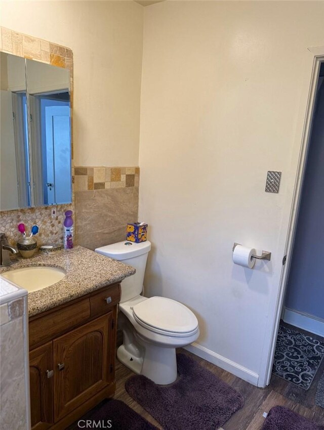 1831 W 68th St, Los Angeles, CA 90047 - bathroom with vanity, toilet, wood finished floors, and baseboards
