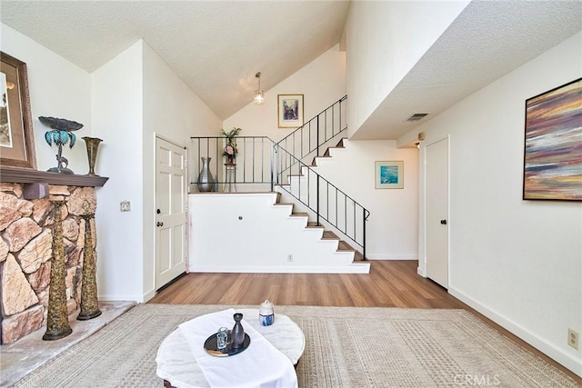 4838 Elrovia Ave Unit E, El Monte, CA 91732 - foyer entrance featuring wood finished floors, stairs, high vaulted ceiling, and baseboards