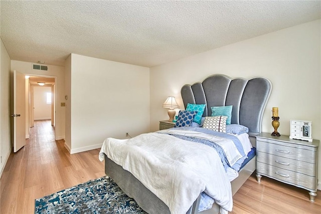 4838 Elrovia Ave Unit E, El Monte, CA 91732 - bedroom featuring light wood-style floors, a textured ceiling, and baseboards